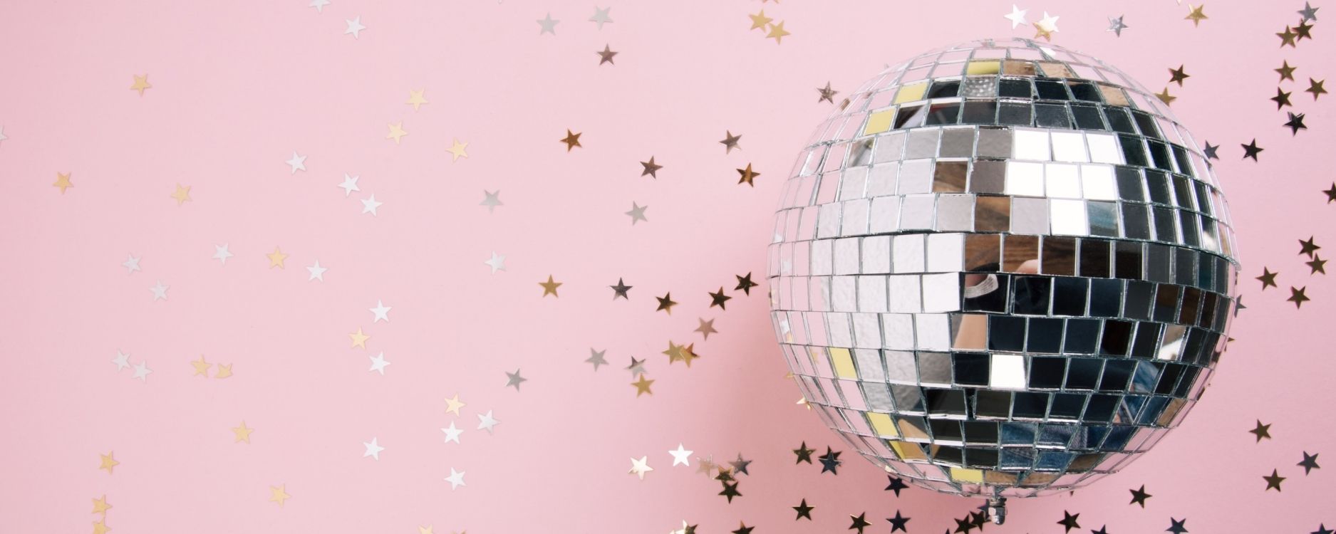 pink background with star confetti and a disco ball - stop getting distracted with shiny object syndrome