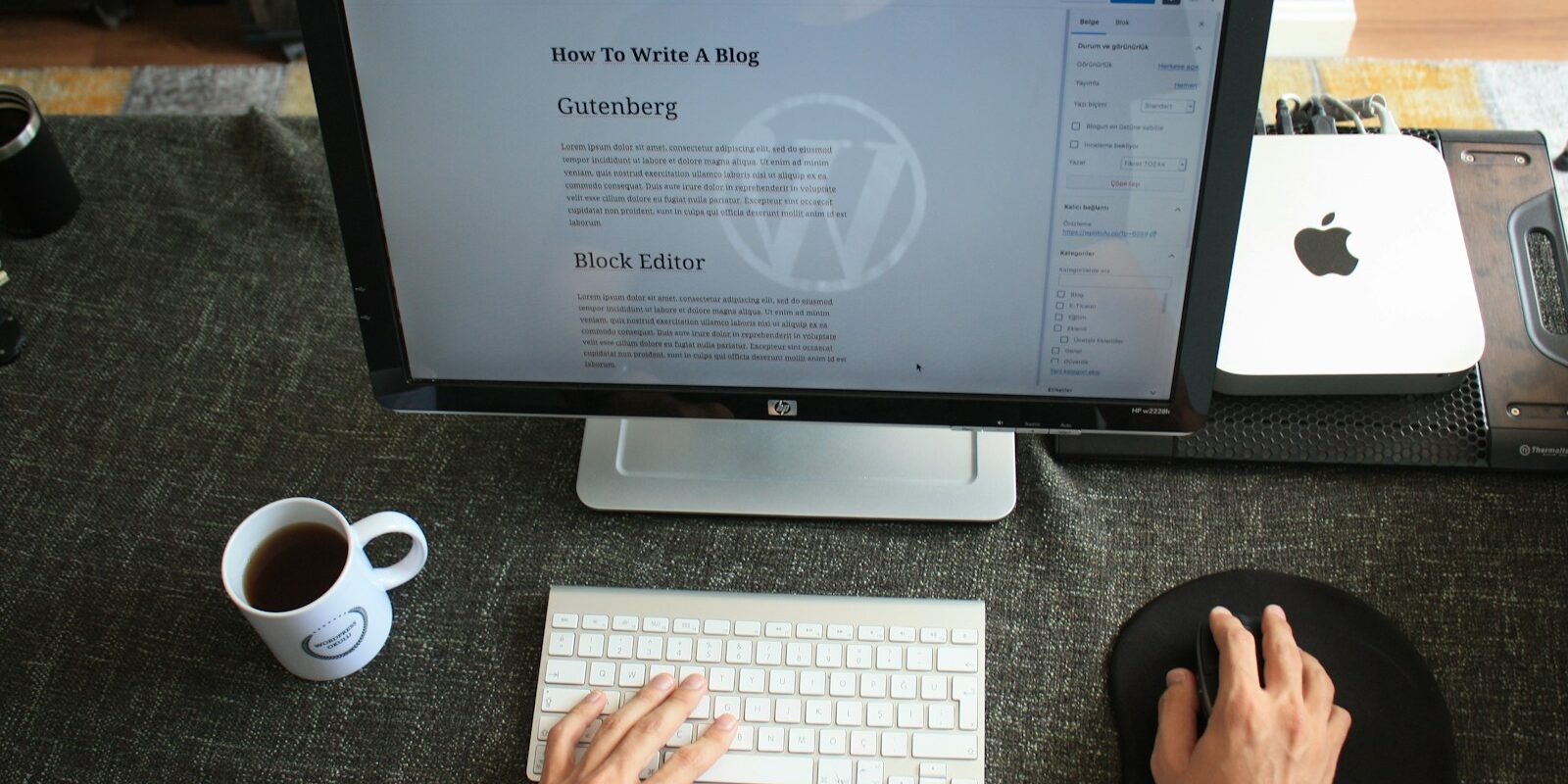 computer monitor showing a wordpress website on the screen with hands on the keyboard and mouse.
